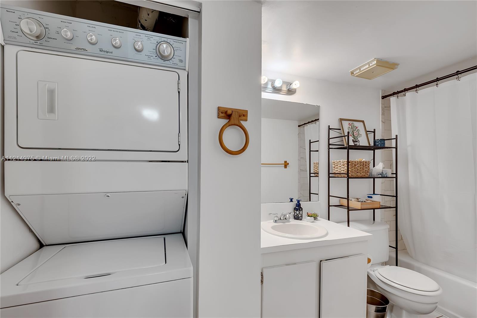 8002 Southwest 149th Avenue, Unit B201 Miami, FL 33193 - Photo 6 of 18 a bathroom with a sink a toilet and mirror