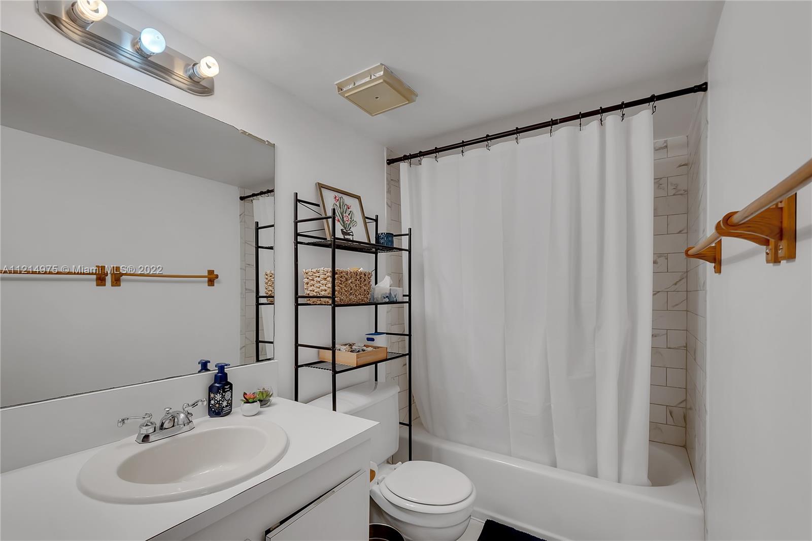 8002 Southwest 149th Avenue, Unit B201 Miami, FL 33193 - Photo 7 of 18 a bathroom with a sink toilet and shower