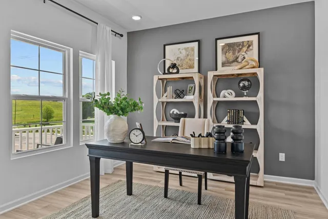 a view of a workspace with furniture and window