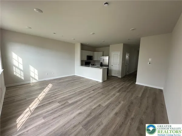 a view of a kitchen with a sink and a refrigerator