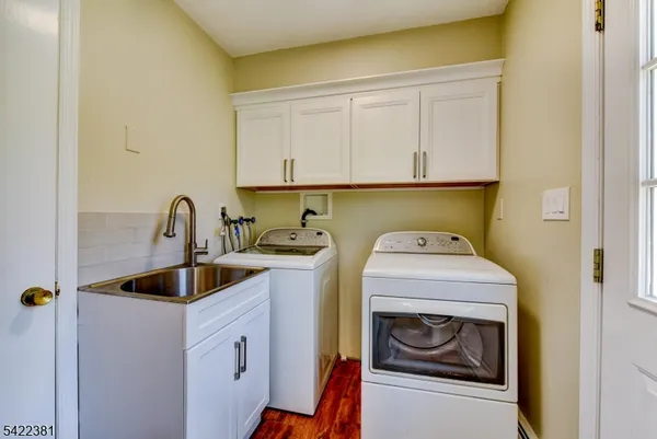 a utility room with sink dryer and washer