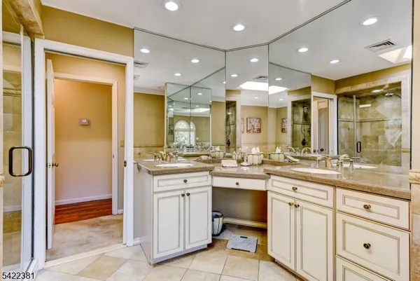 a bathroom with a sink vanity and a mirror
