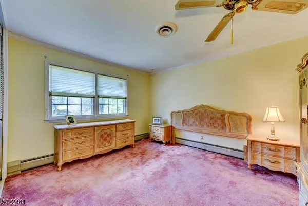 a spacious bedroom with a bed and a table