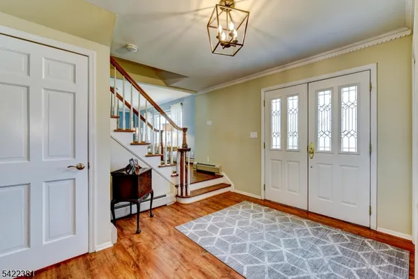 a view of an entryway with wooden floor and a livingroom view