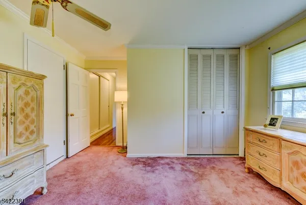 a view of an empty room with window and cabinet