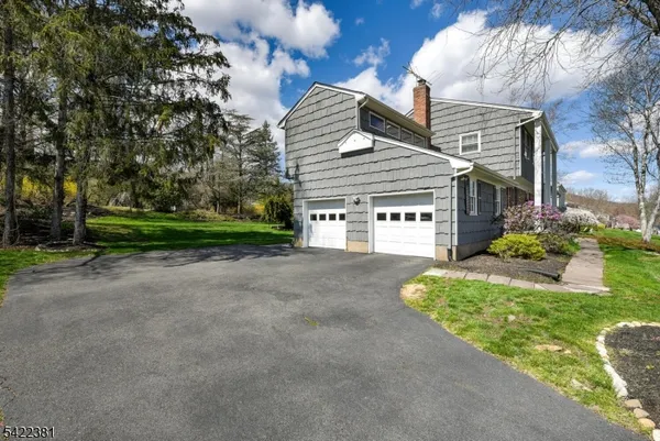 a view of a house with a yard and garage
