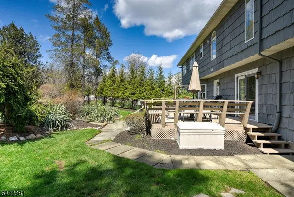 a view of a house with backyard and sitting area
