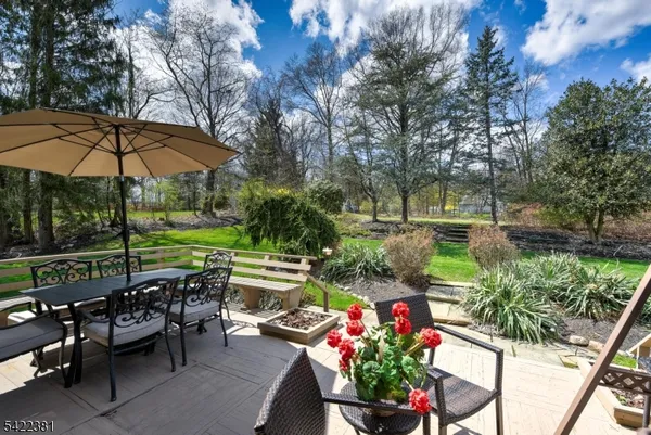 a view of a patio with furniture and a garden