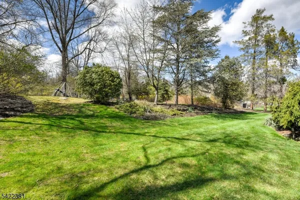 a view of a house with backyard fireplace and sitting area