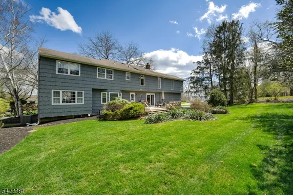a view of a house with backyard sitting area and swimming pool