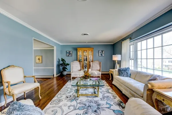 a living room with furniture couches and a large window