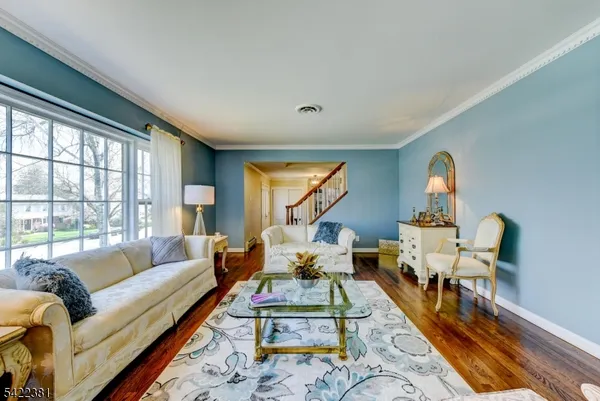 a living room with furniture fireplace and a large window