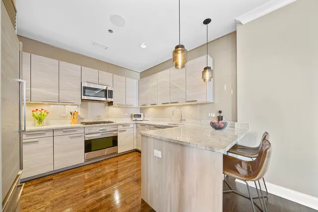a kitchen with stainless steel appliances granite countertop a sink and a stove