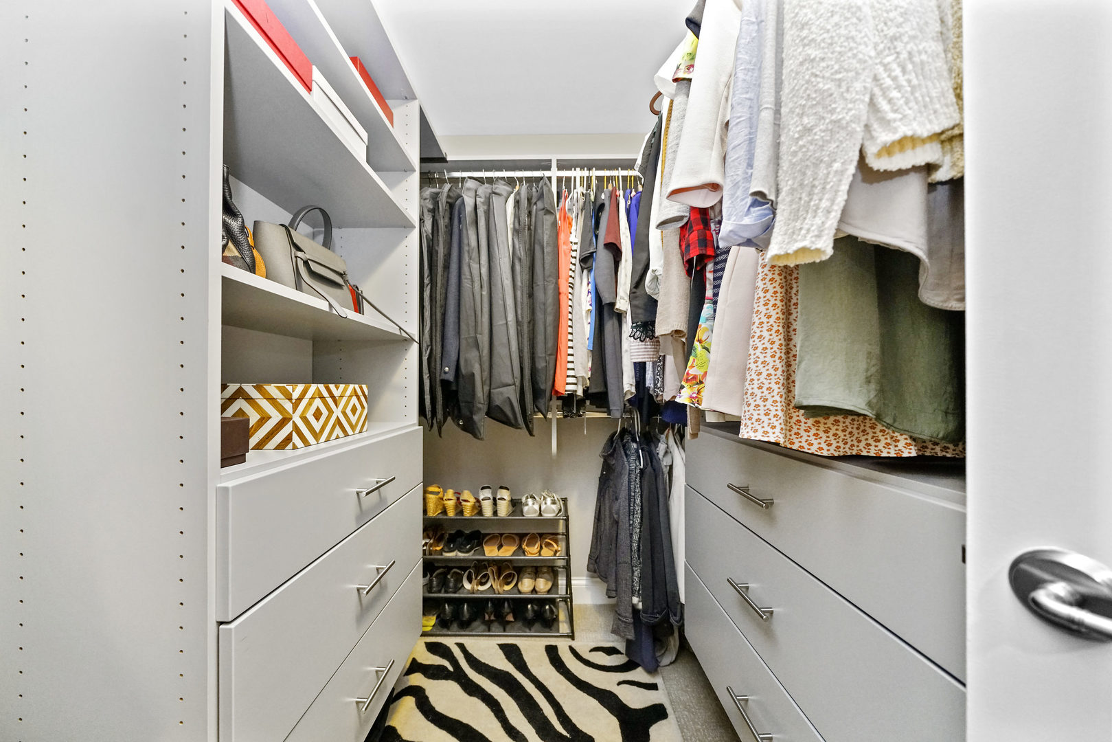 10 East Delaware Place, Unit 18E Chicago, IL 60611 - Photo 22 of 57 a view of walk in closet with clothes and shoes