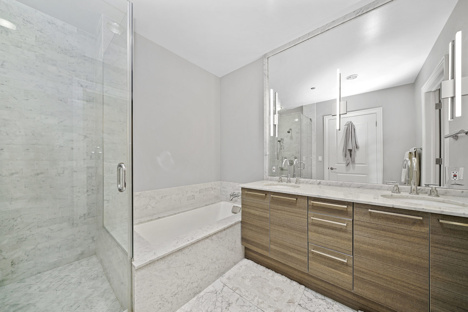 10 East Delaware Place, Unit 18E Chicago, IL 60611 - Photo 24 of 57 a bathroom with a granite countertop sink mirror and a