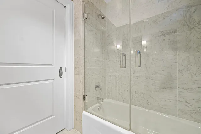 a bathroom with a bathtub and a shower