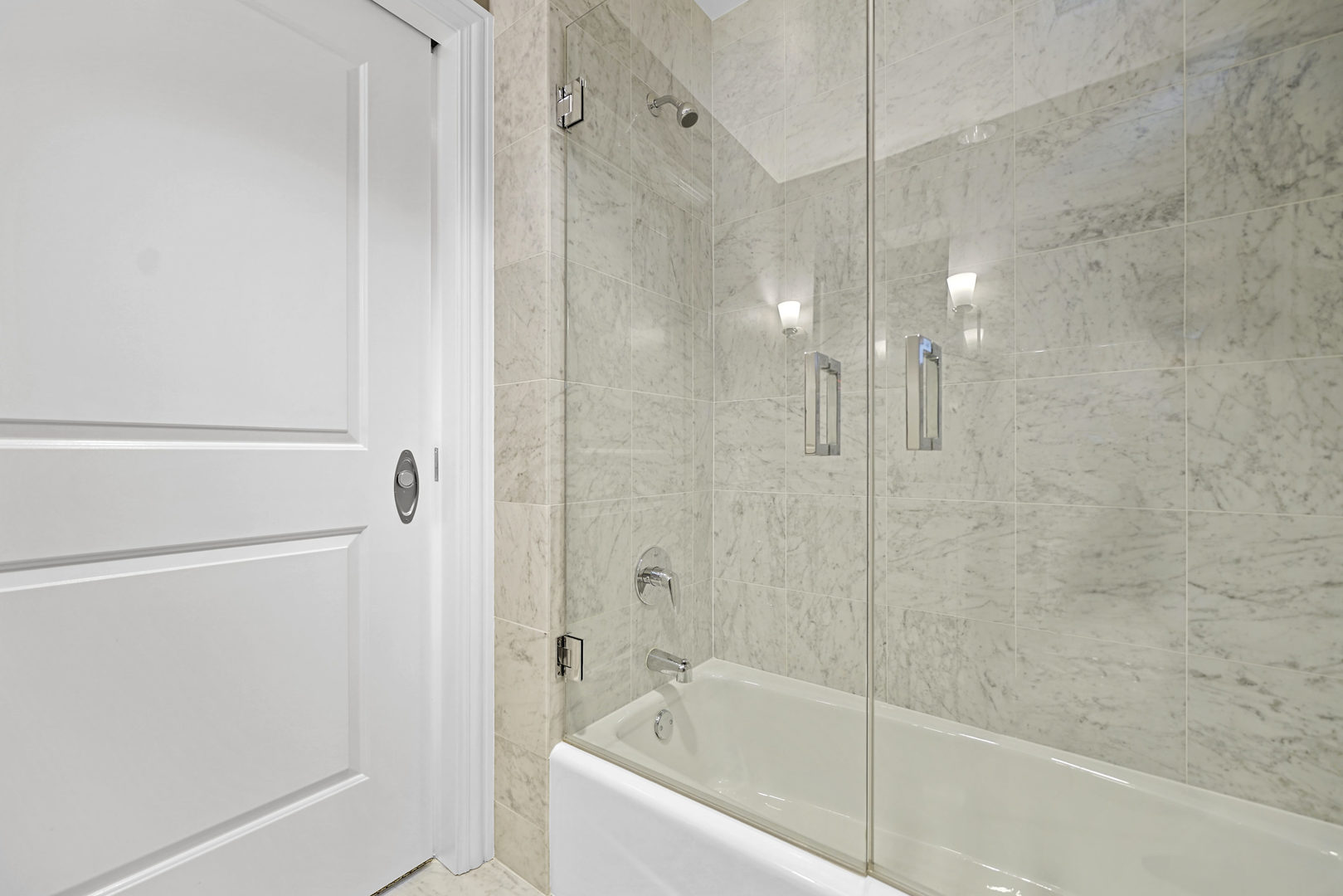 10 East Delaware Place, Unit 18E Chicago, IL 60611 - Photo 29 of 57 a bathroom with a bathtub and a shower