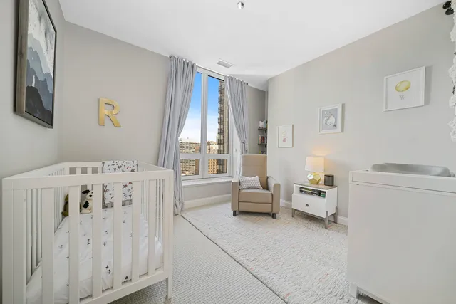 a bedroom with a bed and a white bed