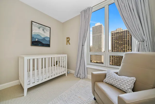 a bedroom with furniture and a large window