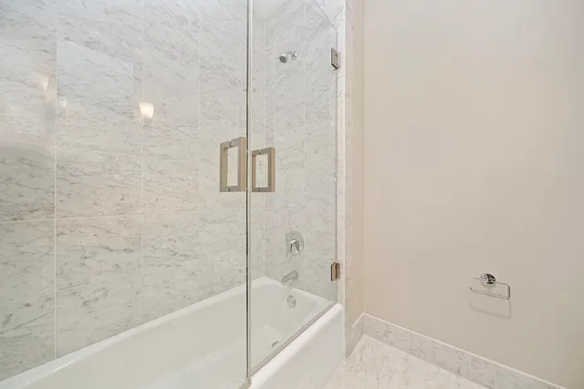a bathroom with a bathtub and shower