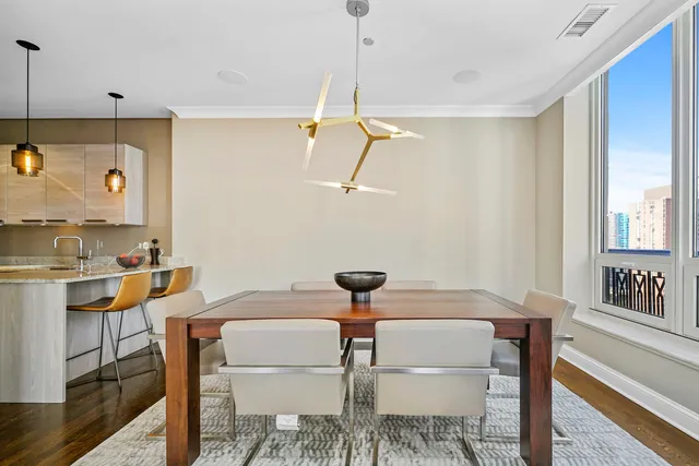 a view of a dining room with furniture and a chandelier