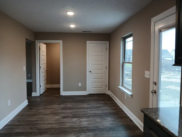 an empty room with a window and a ceiling fan