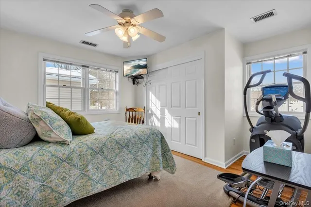 a bedroom with a bed mirror and a window