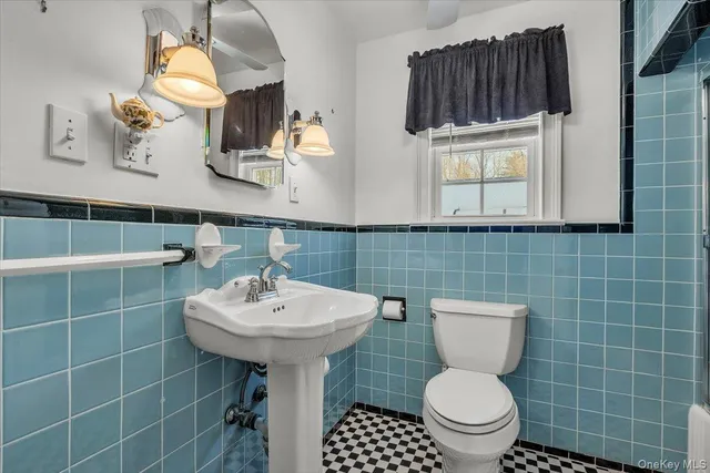 a bathroom with a sink toilet and mirror