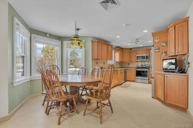 a view of a dining room with furniture window and outside view