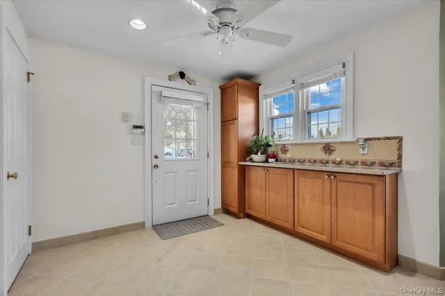 a spacious bathroom with a granite countertop sink a mirror and a bathtub