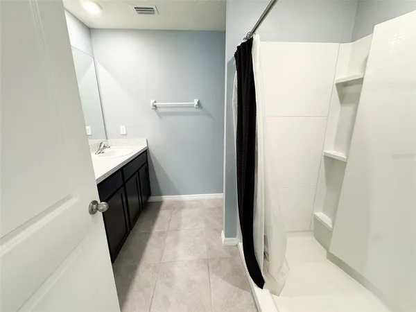 a view of walk in closet with clothes washer and dryer