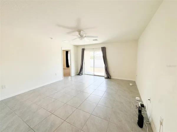 an empty room with a windows and cabinet