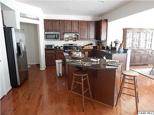 5593 Summerdean Road Crozet, VA 22932 - Photo 2 of 4 a kitchen with stainless steel appliances granite countertop a refrigerator a stove a sink a stove and island with wooden floor