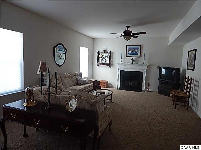 5593 Summerdean Road Crozet, VA 22932 - Photo 4 of 4 a living room with furniture a table and a fireplace