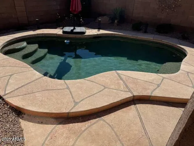 a view of swimming pool from a sink