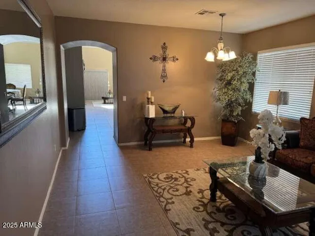 a kitchen with granite countertop a sink a stove top oven a refrigerator a washer and dryer