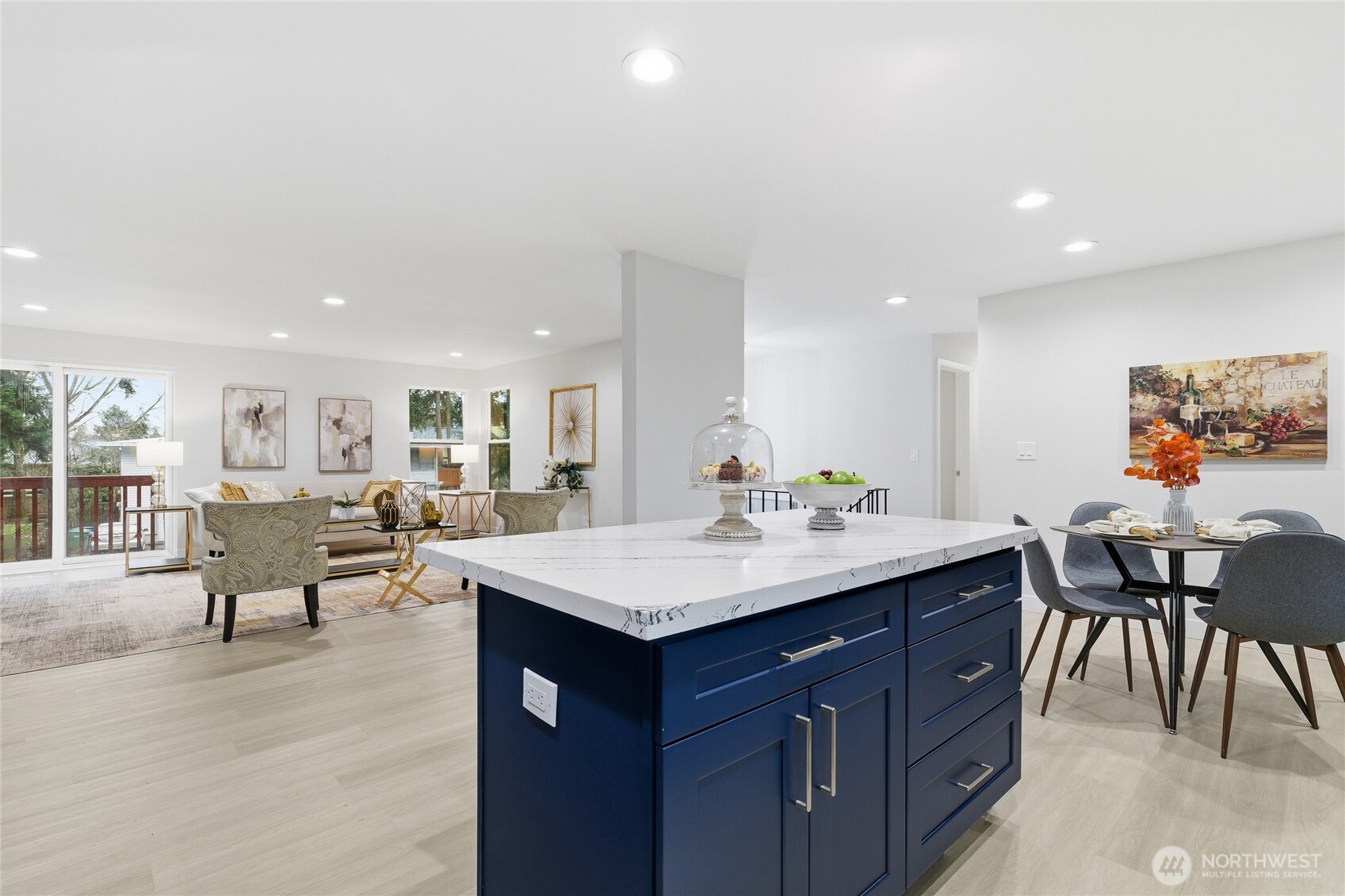 4426 Northeast 17th Street Renton, WA 98059 - Photo 11 of 36 a view of kitchen island sink dining table and chairs