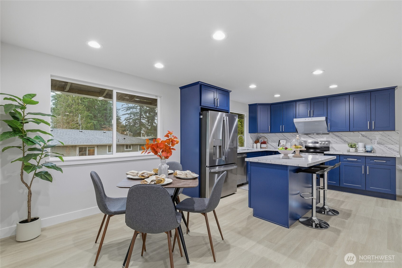 4426 Northeast 17th Street Renton, WA 98059 - Photo 14 of 36 a dining room with furniture a large window and wooden floor