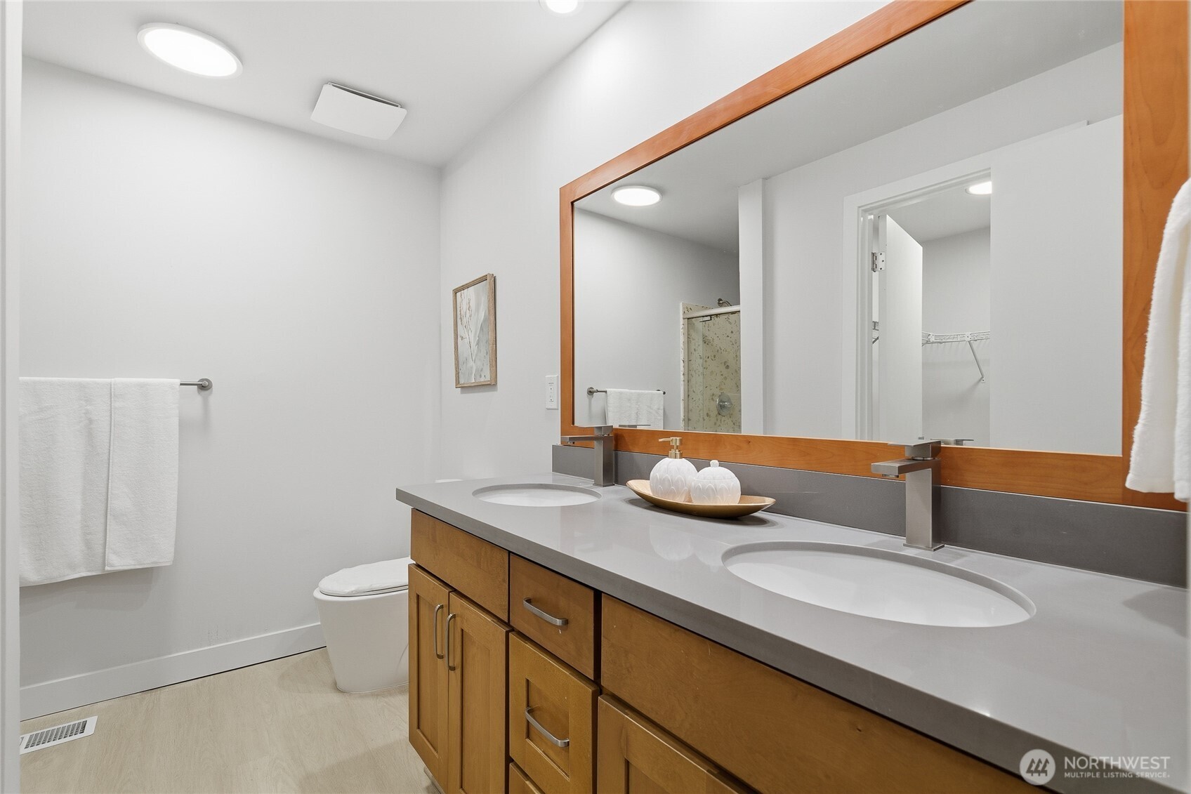 4426 Northeast 17th Street Renton, WA 98059 - Photo 19 of 36 a bathroom with a granite countertop sink a toilet and a mirror