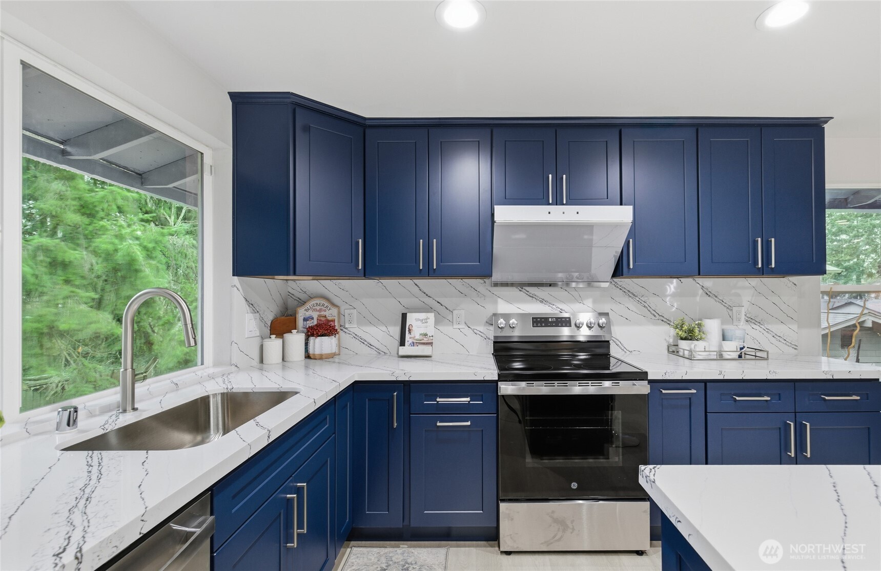 4426 Northeast 17th Street Renton, WA 98059 - Photo 9 of 36 a kitchen with a sink and wooden cabinets