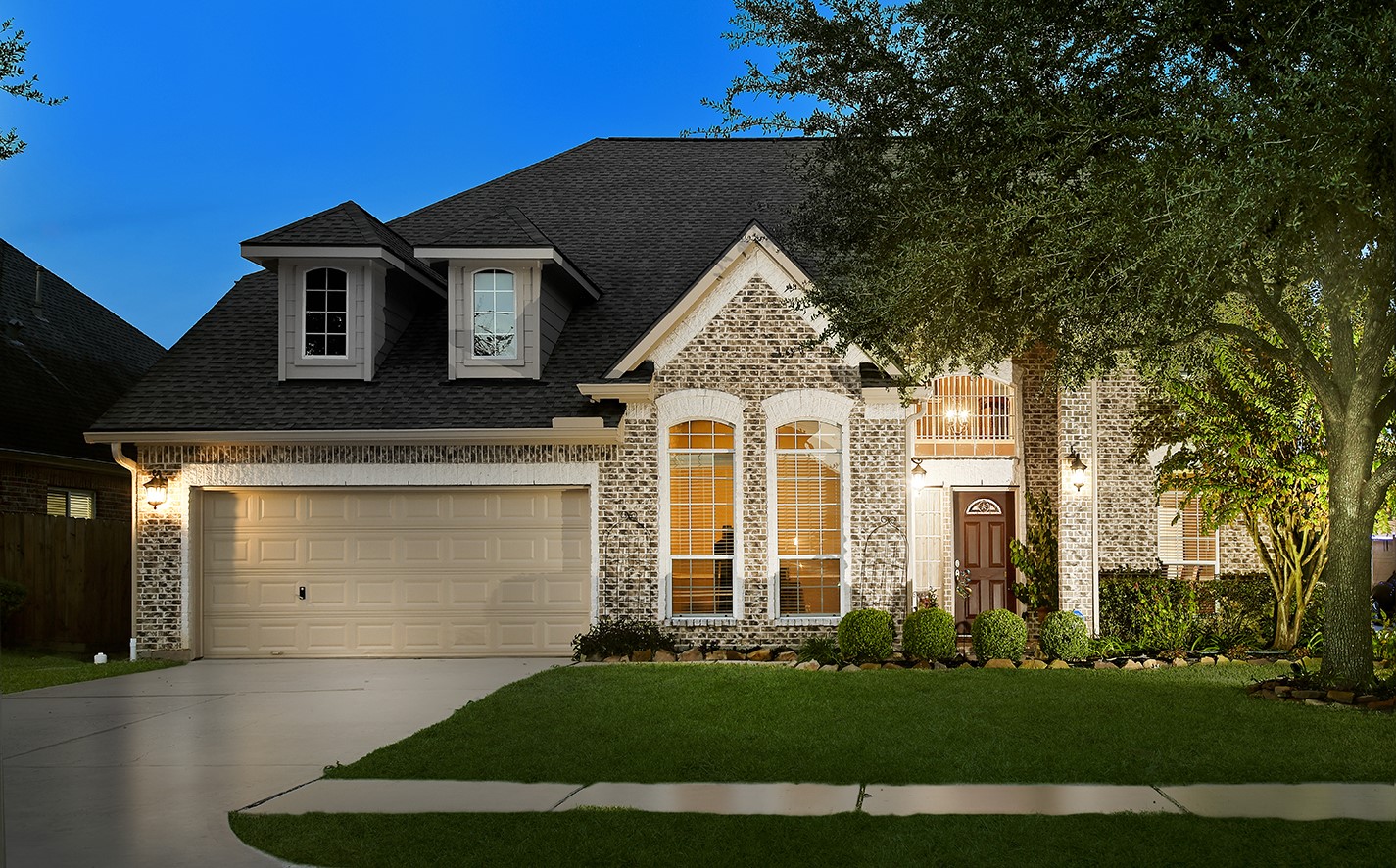 a front view of a house with a yard