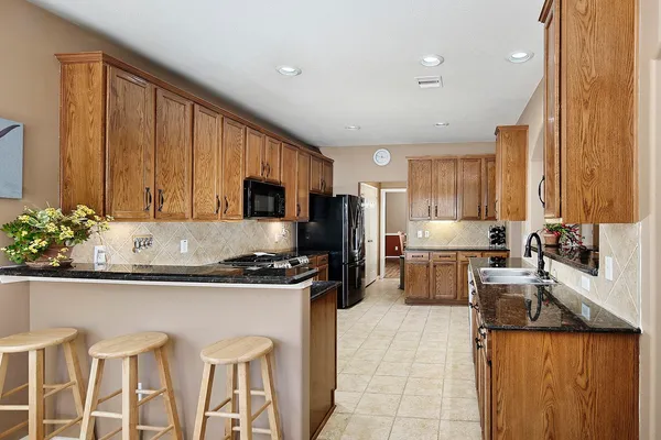 a dining room with furniture a large window and a chandelier