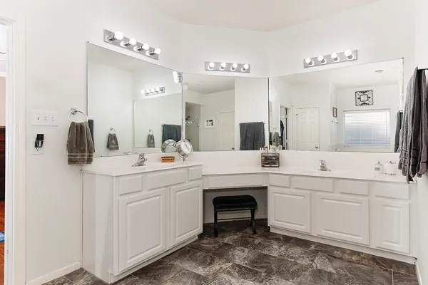 a view of a hallway with wooden floor and a chandelier