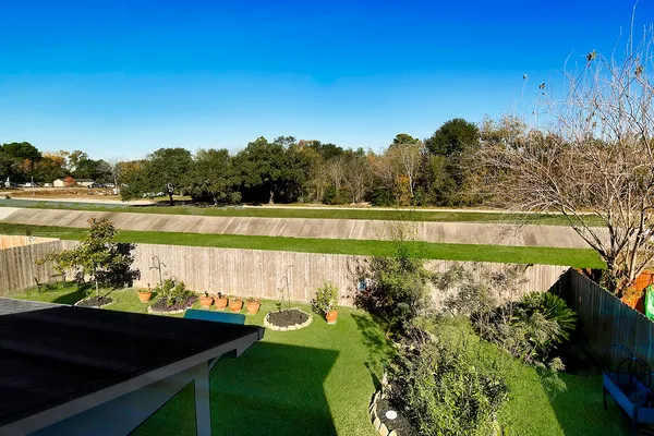 a view of a chair and table on the green field