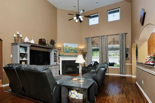 a living room with furniture a fireplace and a flat screen tv