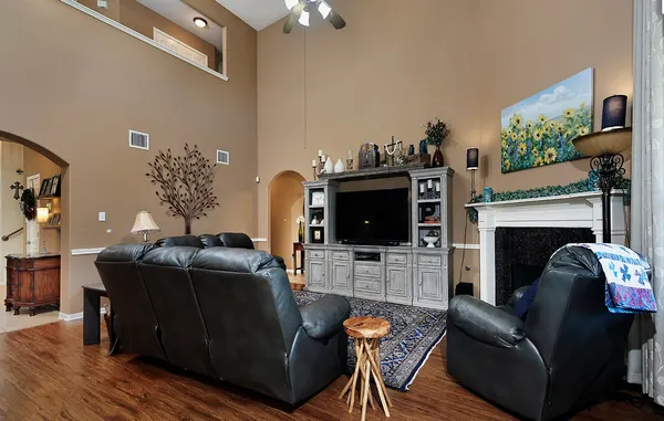 a living room with furniture a fireplace and a flat screen tv
