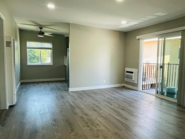 919 Ravenscourt Avenue Campbell, CA 95128 - Photo 4 of 4 an empty room with wooden floor and windows