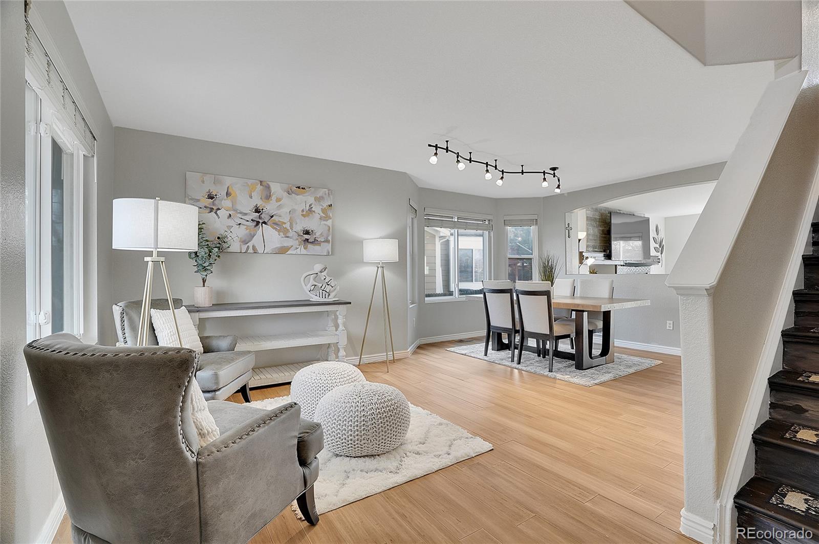 a dining room with furniture and wooden floor