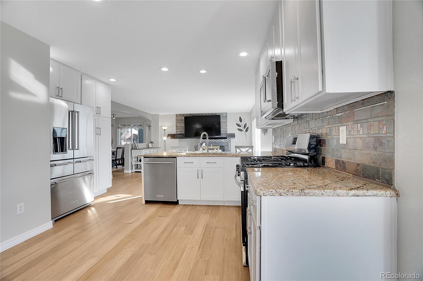 6348 Westview Circle Parker, CO 80134 - Photo 11 of 27 a kitchen with a sink stainless steel appliances and white cabinets