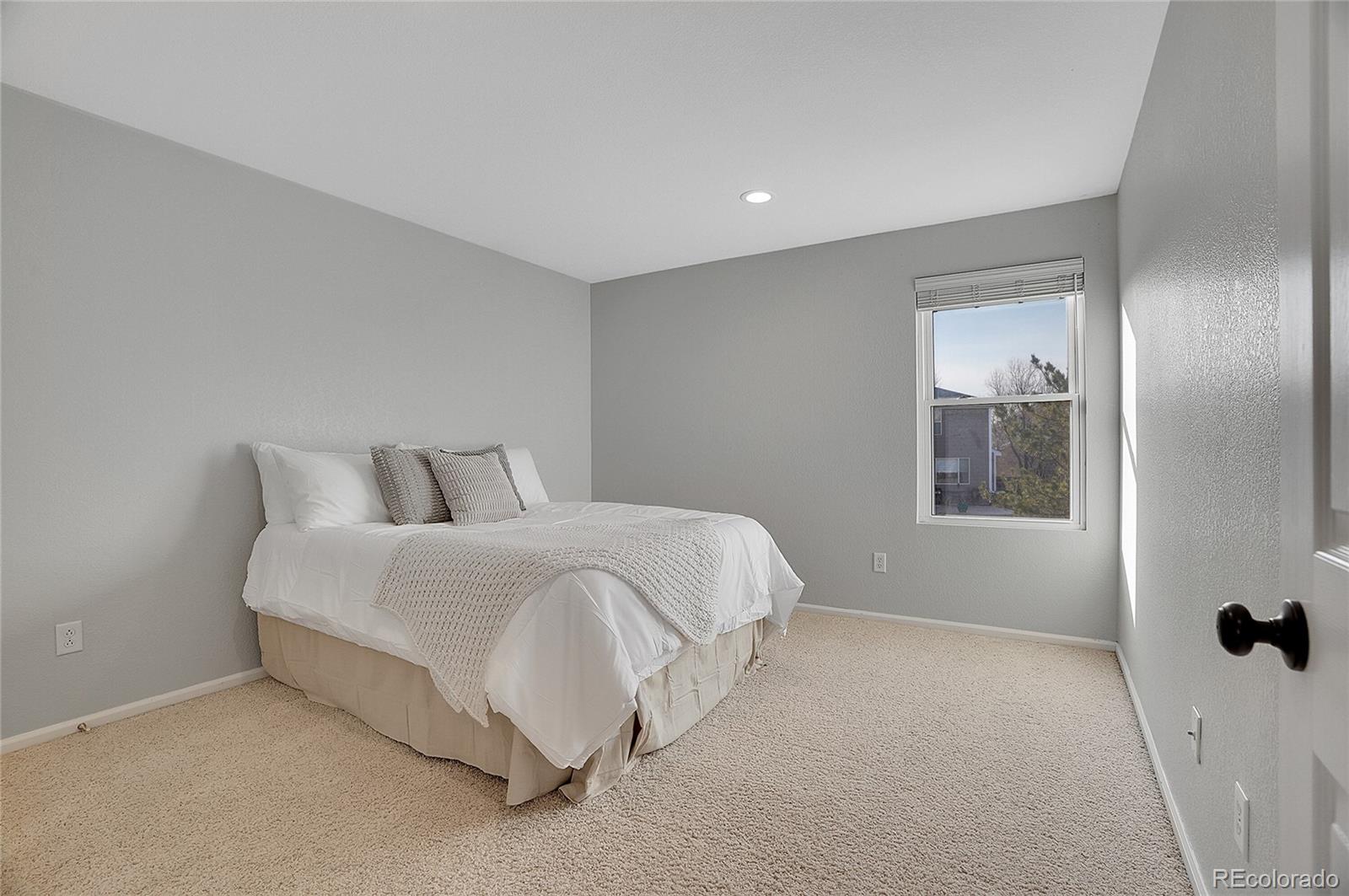 6348 Westview Circle Parker, CO 80134 - Photo 15 of 27 a spacious bedroom with a bed and a window